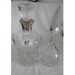 A good quality glass decanter with silver collar and one other.