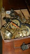 A box of brassware including horse brasses.