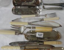 A mixed lot of silver plate crumb scoops, fish knives and forks etc.