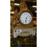 A gilt clock surmounted figure.