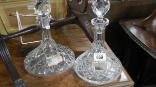 2 cut glass ship's decanters with labels.