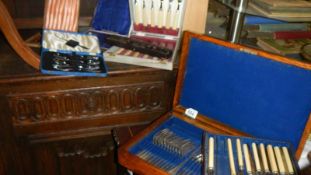 A quantity of cased cutlery sets etc.