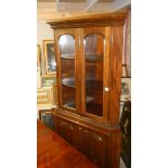 A mahogany floor standing corner cupboard.