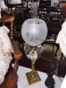 A brass Corinthian column oil lamp with glass font and shade.