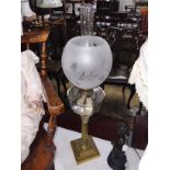 A brass Corinthian column oil lamp with glass font and shade.