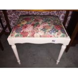 A painted piano stool.