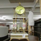 A 4 pillar gilt and porcelain mantel clock.