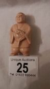 A Victorian ivory netsuke as a figure, signed on foot, in good condition, 2" tall.