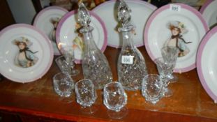 A pair of cut glass decanters and a quantity of glasses.