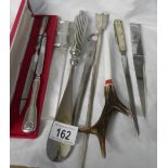 A collection of silver plate and other letter openers.