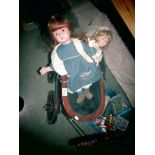 A dolls pram and 2 porcelain dolls.