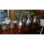 A 4 piece pewter tea set and a metal pot.