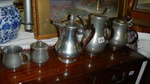 A 4 piece pewter tea set and a metal pot.