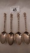 4 silver teaspoons with cherub finials.