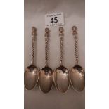 4 silver teaspoons with cherub finials.