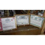 3 framed and glazed share certificates.