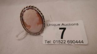 An old silver cameo ring, a silver brooch set cornelian? both in good condition.