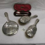 A cased silver spoon and fork, 2 silver backed brushes and a silver backed mirror.