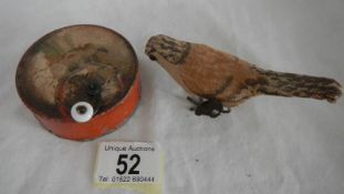 A 19th century circular child's musical box and an old wind up bird.