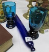 A Bristol blue glass rolling pin and a pair of blue glass vases.