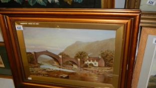 A framed and glazed watercolour rural scene with bridge.