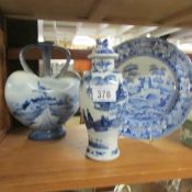A blue and white flask, lidded vase and plate.