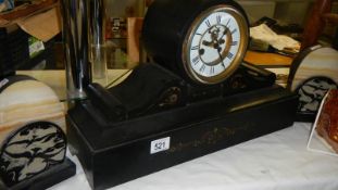 A black mantel clock and a pair of clock side pieces.