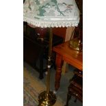 A brassed standard lamp with bird decorated shade.