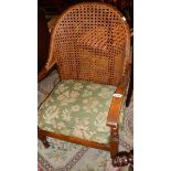 A cane backed arm chair.