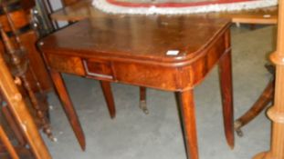 A mahogany fold over tea table.