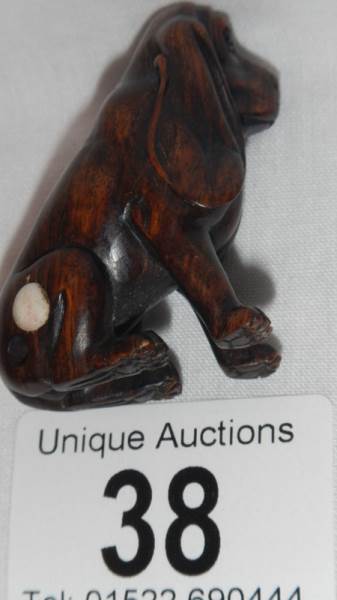 A carved rosewood netsuke as a dachsund, with small ivory disc inset, 2" tall, in good condition. - Image 2 of 2