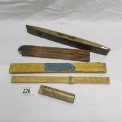 A slide rule for textile calculation, 2 other slide rules and a spirit level.