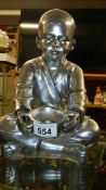 A silver coloured Buddha,