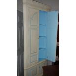 A painted corner cupboard.