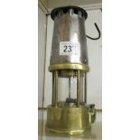 A brass and metal miner's lamp.