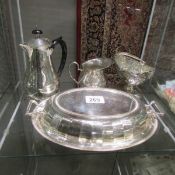 A silver plated tureen with cover, coffee pot, jug and basket.