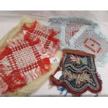 A beaded evening bag and 2 sets of hand made doilies.