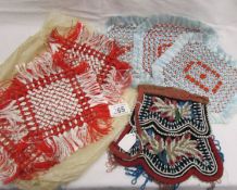 A beaded evening bag and 2 sets of hand made doilies.