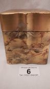 A Chinese lacquered card case in gold coloured finish with painting of village scene.