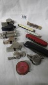 A mixed lot of pen knives, old whistles, tape measure etc.