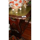 A coffee table with leather inset top.