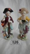 A pair of continental porcelain figures, 4.5" tall, in good condition.