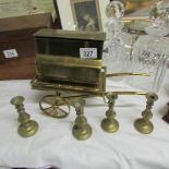 A musical brass street organ and 4 small brass candlesticks.