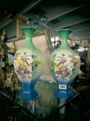 A pair of bird decorated vases.