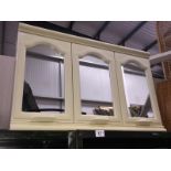 A triple doored mirrored bathroom cabinet