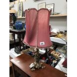 An ornate brass table lamp with decorative shade