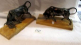 2 art deco style metal figures of bulls.