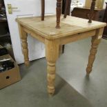 A small pine kitchen table.