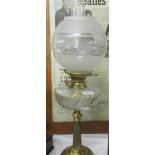 A brass oil lamp with brass font and complete with shade and chimney.
