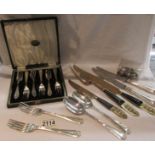 A cased set of 6 cake forks, a carving set, other cutlery and place card holders.